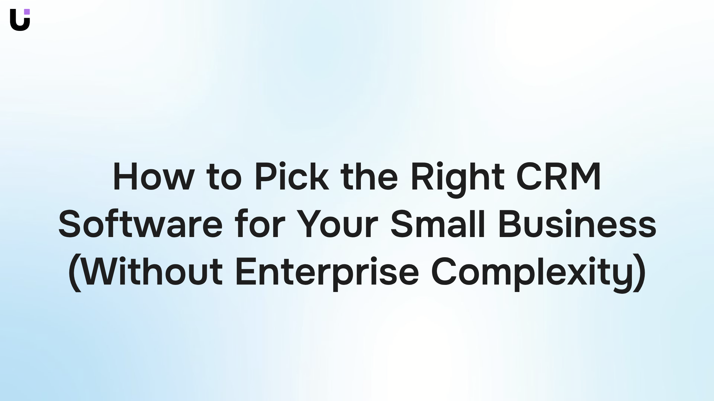 Clean desk workspace with laptop displaying CRM dashboard interface, representing simple business software management